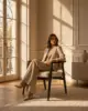 Lois Dining Chair shown in a hotel interior with a seated guest