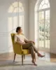 Alice Lounge Chair shown in a hotel interior with a seated guest