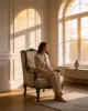 Anne Wing Chair shown in a hotel interior with a seated guest