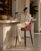 Bennet Bar Stool shown in a hotel interior with a seated guest