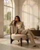 Kemp Lounge Chair shown in a hotel interior with a seated guest