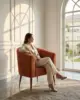 Quilted tub chair shown in a hotel interior with a seated guest