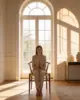 Wish Bone Dining Chair shown in a hotel interior with a seated guest